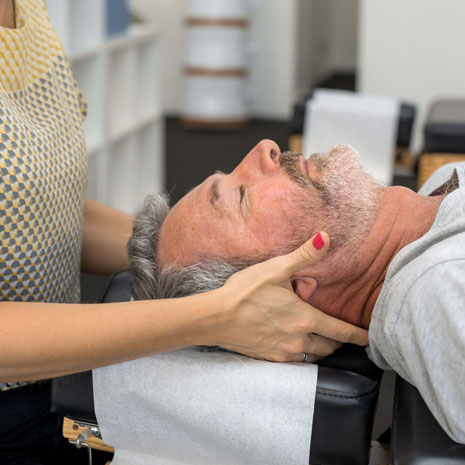 chiropractor adjusting a man’s neck