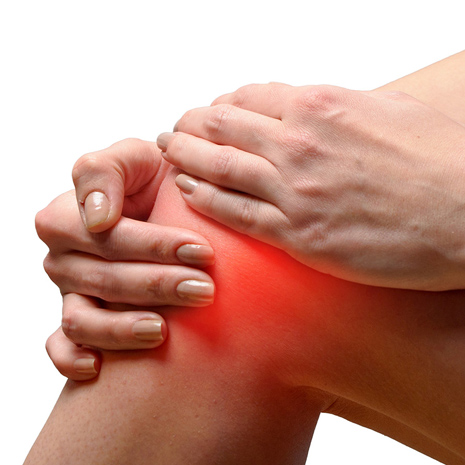 An image of a person holding their knee in pain